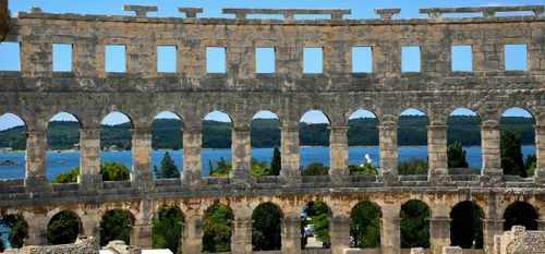 Immagine con mare, archi, acqua, alberi, romano, cielo, finestre, montagne, rudere, lago, rovine, anfiteatro
