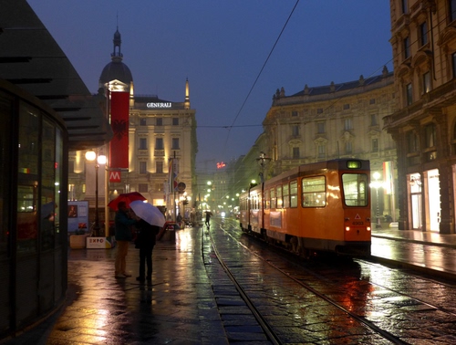 Immagine con pioggia, tram, ombrelli, luci, binari, città, notturno, rotaie, palazzi, notte, persone, bagnato, sera, strada, ombrello